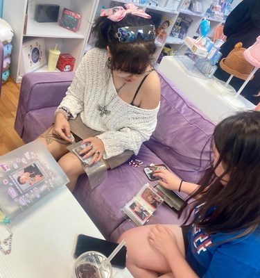 Fans trading photocards on the purple couch